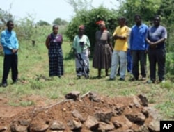 Thuli Makama visits the grave of a villager killed by a game park ranger in Swaziland.