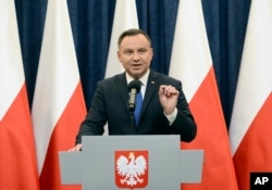 Polish President Andrzej Duda announces his decision to sign a legislation penalizing certain statements about the Holocaust, in Warsaw, Poland, Tuesday, Feb. 6, 2018.