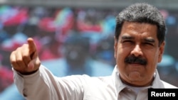 Venezuela's President Nicolas Maduro greets supporters during a campaign rally in Charallave, Venezuela, May 15, 2018.