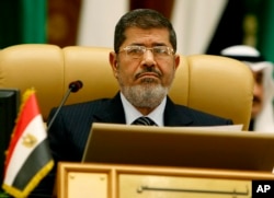 FILE - Then-President Mohamed Morsi of Egypt attends the third session of the Arab Economic Summit, in Riyadh, Saudi Arabia, Jan. 21, 2013.