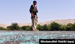 FILE - An Afghan soldier keeps watch during clashes with Islamic State militants in Kot district of Nangarhar province, Afghanistan, June 26 2016.