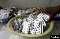 FILE - Ruth Munyao, a pharmacist, dispenses antiretroviral (ARV) drugs at the Mater Hospital in Kenya's capital Nairobi, Sept. 10, 2015.