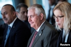 FILE - Secretary of State Rex Tillerson, center, sits with other diplomats before a meeting on Syria in Bonn, Germany, Feb.17, 2017.