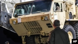 In this photo provided by U.S. Forces Korea, a truck carrying parts of U.S. missile launchers and other equipment needed to set up the Terminal High Altitude Area Defense (THAAD) missile defense system arrive at the Osan base, South Korea, Monday, March 6, 2017. (U.S. Force Korea via AP)
