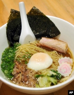 In this Thursday, Nov. 10, 2011 photo, a bowl of Momofuku Ramen, which consists of pork belly, pork shoulder and poached egg, is photographed at David Chang's Momofuku Noodle Bar in New York. (AP Photo/Diane Bondareff)