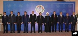 In this photo released by Associated Press of Pakistan, leaders and representatives of the member states of the 10-nation Economic Cooperation Organization pose for group photo during the 13th ECO summit in Islamabad, Pakistan, March 1, 2017.