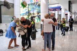 People reunite at Sydney Airport in the wake of COVID-19 border restrictions easing, with fully vaccinated Australians being allowed into Sydney from overseas without quarantine for the first time since March 2020, in Sydney, Australia, November 1, 2021.