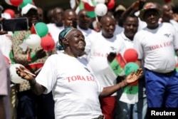 A supporter of Burundi's ruling party, the National Council for the Defense of Democracy-Forces for the Defense of Democracy (CNDD-FDD), dances during their final rally ahead of the referendum in Bujumbura, Burundi, May 14, 2018.