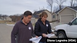 Joe Enriquez Henry with the League of United Latin American Citizens goes door-to-door to urge people to vote in Des Moines, Iowa. Iowa's first-in-the-nation caucuses kick off the U.S. primary election season Monday.