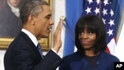 FILE - President Barack Obama is officially sworn-in by Chief Justice John Roberts in the Blue Room of the White House, Jan. 20, 2013.