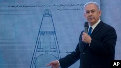 Israeli Prime Minister Benjamin Netanyahu presents material on Iranian nuclear weapons development during a press conference in Tel Aviv, April 30 2018.