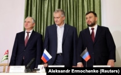UKRAINE -- (E-L) Denis Pushilin, newly elected head of the separatists in the Donetsk region, head of Crimea Sergei Aksyonov and prime minister of Georgia's breakaway region of Abkhazia Valery Bganba attend an inauguration ceremony in Donetsk, November 20.