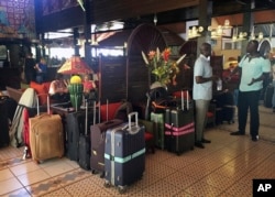 British and Dutch tourists wait in the lobby of their hotel to be taken to Banjul Airport, in Gambia, Jan. 18, 2017.