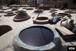 Artisans blend indigo, ash and potassium to make their traditional blue dye in Kano, Nigeria, Nov. 9, 2014. (Chris Stein/VOA)