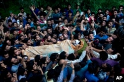 Kashmiri villagers carry body of Burhan Wani, chief of operations of Indian Kashmir's largest rebel group Hizbul Mujahideen, during his funeral procession in Tral, some 38 Kilometers (24 miles) south of Srinagar, Indian-controlled Kashmir, July 9, 2016.