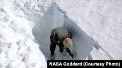To measure snowpacks, researchers dig snowpits down to bare ground.