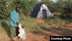 A man pours camel milk in Kenya. (Sharon Deem, Saint Louis Zoo)