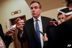 FILE - Senate Intelligence Committee Vice Chairman Sen. Mark Warner, D-Va., speaks with reporters on Capitol Hill in Washington, Sept. 27, 2017.