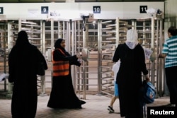 Saudi women arrive to watch the soccer match between Al-Ahli against Al-Batin at the King Abdullah Sports City in Jeddah, Saudi Arabia, Jan. 12, 2018.