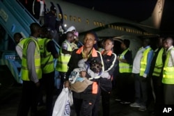 Nigerian returnees from Libya disembark from a plane upon arrival at the Murtala Muhammed International Airport in Lagos, Nigeria, Dec. 5, 2017.
