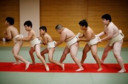 Kyuta Kumagai, 10, warms up with other boys before training, at Komatsuryu sumo club in Tokyo, Japan, August 23, 2020. "It is fun to beat people older than me," said Kyuta. (REUTERS/Kim Kyung-Hoon)