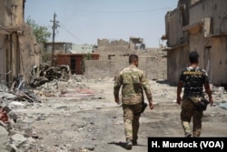 Many residents of Hassan Sham camp have been displaced in recent months from west Mosul, where neighborhoods are in like this one are in tatters as Iraqi forces beat back IS militants on June 13, 2017.