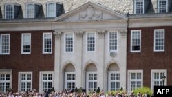 People wait to see the arrival of US President Donald Trump and US first lady Melania Trump at Winfield House in London