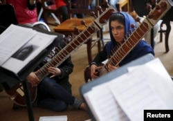 Members of the Zohra orchestra, an ensemble of 35 women, attend a rehearsal at Afghanistan's National Institute of Music, in Kabul, April 4, 2016.