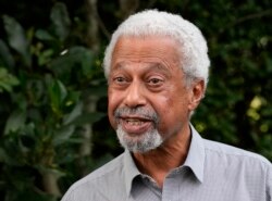 Tanzanian writer Abdulrazak Gurnah gestures as he poses for a photo at his home in Canterbury, England, Oct. 7, 2021.