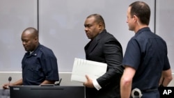 FILE - Jean-Pierre Bemba enters the courtroom of the International Criminal Court in The Hague, Netherlands, March 21, 2016. The court's judges handed him a guilty verdict.