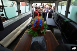 Nangarhar officials hand over the body of Tahir Dawar, a Pakistani police officer, to Pakistani tribal elders in Jalalabad, east of Kabul, Afghanistan, Nov. 15, 2018.