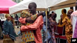 One of the freed Chibok girls is embraced by a family member during a reunion ceremony in Abuja, Nigeria, Oct. 16, 2016.