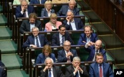 Lawmakers from the Law and Justice party listen to debate on changes to a controversial Holocaust law, in Warsaw, Poland, June 27, 2018.