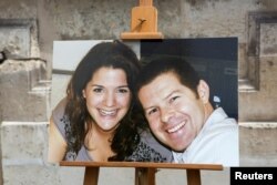 The portraits of French police commander Jean-Baptiste Salvaing (R) and his companion, administrative agent Jessica Schneider are seen at a ceremony in the courtyard at the Interior Ministry in Paris, June 15, 2016.