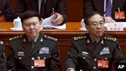 Zhang Yang, left, a Chinese military official who committed suicide while under investigation for corruption, at the China's National People's Congress, March 8, 2017.