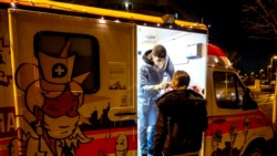 A woman is tested at a mobile Covid-19 test station in Frankfurt, Germany, Jan. 17, 2022.