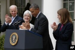 President Barack Obama and Vice President Joe Biden stand with outgoing Health and Human Services Secretary Kathleen Sebelius, second from left, and his nominee to be her replacement, Budget Director Sylvia Mathews Burwell, April 11, 2014.