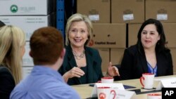 Democratic presidential candidate Hillary Rodham Clinton, center, speaks during a small business roundtable, April 15, 2015, in Norwalk, Iowa.