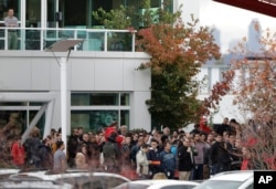 Google employees gather in a courtyard as they take part in a walkout from their jobs at the Google campus in Kirkland, Washington, Nov. 1, 2018.