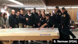 California authorities show President Donald Trump where fire damage occurred in the Paradise, Calif., area, Nov. 17, 2018. At left is Paradise Mayor Jody Jones. At least 71 people died, more than 1,000 are missing and 9,700 homes were destroyed.