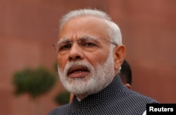 FILE - India's Prime Minister Narendra Modi speaks to the media inside the parliament premises in New Delhi.