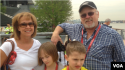 A family of Alaskan tourists were happy to unexpectedly be a part of New York's Fleet Week, New York City, May 23, 2014. (Adam Phillips/VOA)