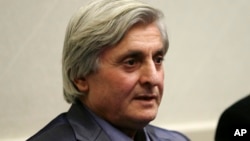 FILE - Syrian refugee Refaai Hamo addresses the media during a news conference in Romulus, Mich.