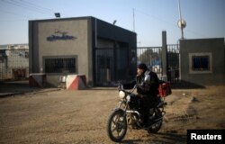 A Palestinian rides a motorcycle outside Kerem Shalom, the main passage point for goods entering Gaza, after it was shut down by Israel, in the southern Gaza Strip, Jan. 14, 2018.