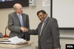 FILE - Ashim Mitra, in an undated photo on right, is seen as he learns he was selected for a President’s Award. (Photo by Janet Rogers/Strategic Marketing and Communications)