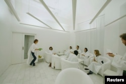 In Sweden, where lack of winter sunlight can contribute to depression, customers dressed in white robes take in simulated sunlight at Stockholm's Iglo Ljuscafe, Dec. 12, 2006.