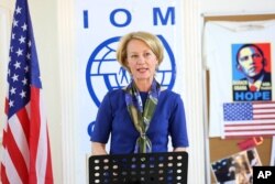 In this photo taken Aug. 28, 2016, the U.S. ambassador to Jordan, Alice Wells, addresses three Syrian families ahead of their departure to the United States. The families were part of a year-long U.S. resettlement program.