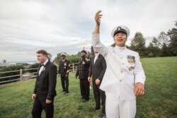 Sitthikorn Kanjaiya, front, is a Thai-born Navy Chief Petty Officer, based in Seattle, Washington.