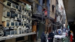FILE - Discarded television sets are stacked up in an alleyway in an area known for storing electronic waste in New Delhi, India, Dec. 8, 2018.