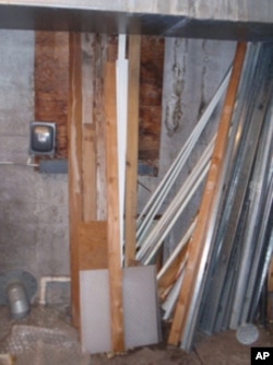 The horizontal wood slats in this utility room cover up a long unused tunnel that's thought to lead to an adjacent building.